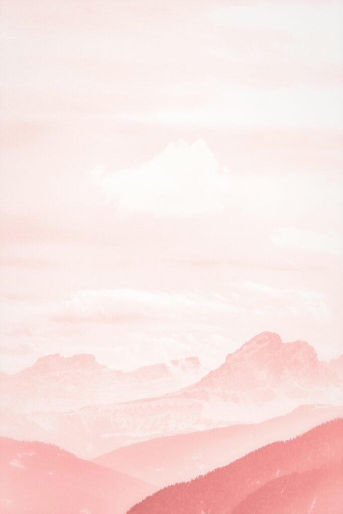 A soft pink pastel mountain landscape, perfect for aesthetic backgrounds or wallpapers.